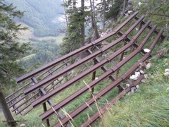 Avalanche/rockslide trap.  Keeps things from careening down the hill.