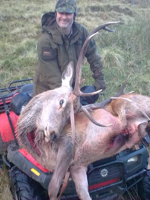 Cliff with my stag on the quad bike.  He's off to fetch Dieter's stag further back in the valley now.