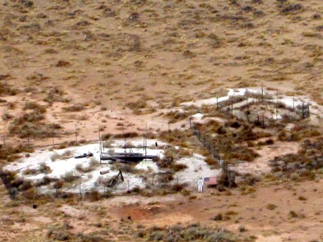 REALLY zooming in.  See the 6 foot tall astronaut cutout holding a 3 foot by 5 foot U.S. flag?  That's how awesomely big this thing is! 

The white areas are remnants from when people tried to recover the iron from the meteor.  Most of it evaporated on impact as molten droplets.