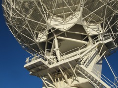 The dish is aimed with these gears for elevation and tracks on the pedestal for azimuth.  There is also refrigeration plants to super-cool the sensors to just above absolute zero.